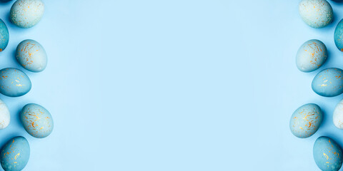 Easter frame of eggs painted in blue color. Flat lay, top view.