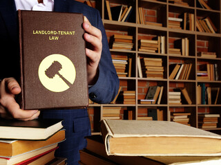  LANDLORD-TENANT LAW book in the hands of a attorney. Landlord-tenant law governs the rental of commercial and residential property. 