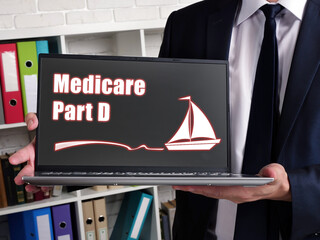 Business concept meaning Medicare Part D with sign on card in hand.
