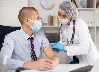 Vaccination of an office worker in a company office