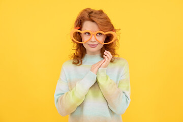 fashion model. pretty lady on yellow background. funny redhead woman in party glasses.