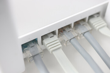 White internet router with connected wires closeup