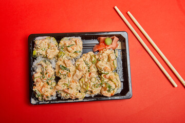 Take out Sushi Volcano Roll on a plastic container