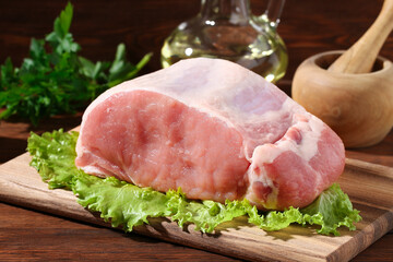 Raw pork loin. Pork meat on a wooden background. Closeup.