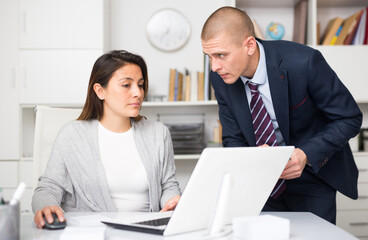 Businessman and businesswoman working together at office