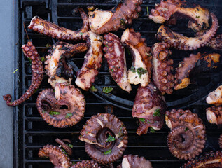 Cooking octopus on a barbeque grill - 422224618