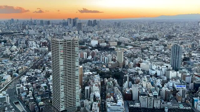 TOKYO, JAPAN : Aerial sunset CITYSCAPE of TOKYO. View of dawn sky and buildings around Ikebukuro and Shinjuku city. Japanese city life and urban metropolis concept. Time lapse video, dusk to night.