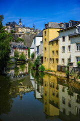 Fototapeta na wymiar Luxembourg city, Luxembourg - July 16, 2019: Cozy riverside houses in Luxembourg city on a sunny summer day