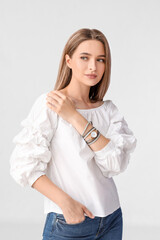 Woman with stylish wrist watch on white background