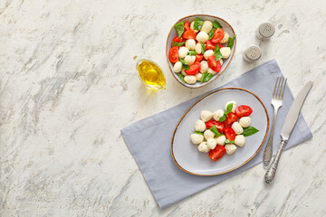 Composition with mozzarella cheese, tomatoes and basil on grunge background