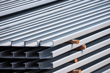 Stack of C light lip channel steel material in gray rustproof color in construction site area