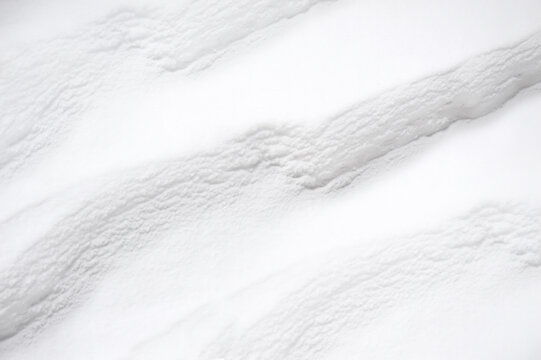 Layers of white snow in spring. Diagonal abstraction. Snowdrift background. Drawing for fabric