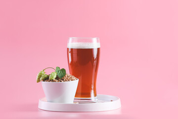 Tray with glass of fresh beer on color background