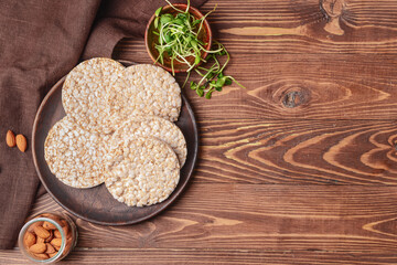 Tray with rice crackers on wooden background