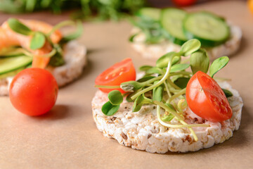 Rice cracker with tomatoes on parchment, closeup