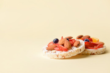 Tasty rice crackers on color background