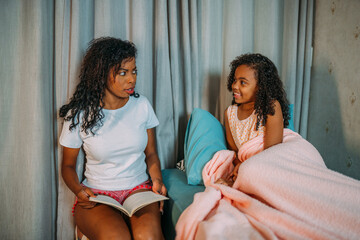 Loving latinx Mother Reads Bedtime Stories to Her Daughter