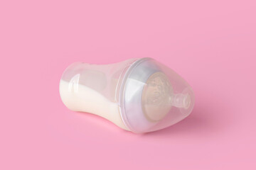 Bottle of milk for baby on color background