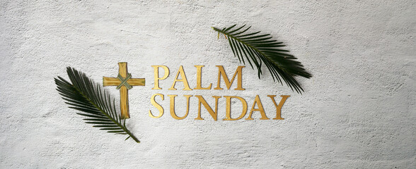 Palm sunday background. Cross and palm on grey background.