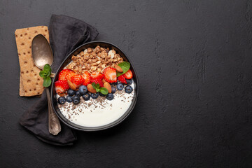 Healthy breakfast with granola, yogurt and fresh berries