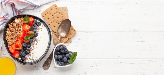 Healthy breakfast with granola, yogurt and fresh berries