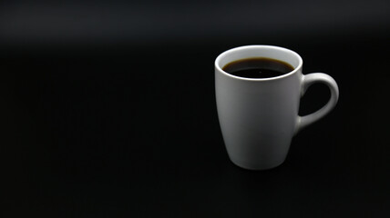 Close up black hot coffee white mug with black background.