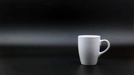 Close up black hot coffee white mug with black background.