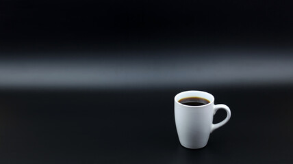 Close up black hot coffee white mug with black background.