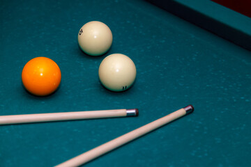 Billiard balls and cue on pool table. Russian billiards. Close-up of items for the game. Background space. Concept of sports games. Place for an inscription or logo