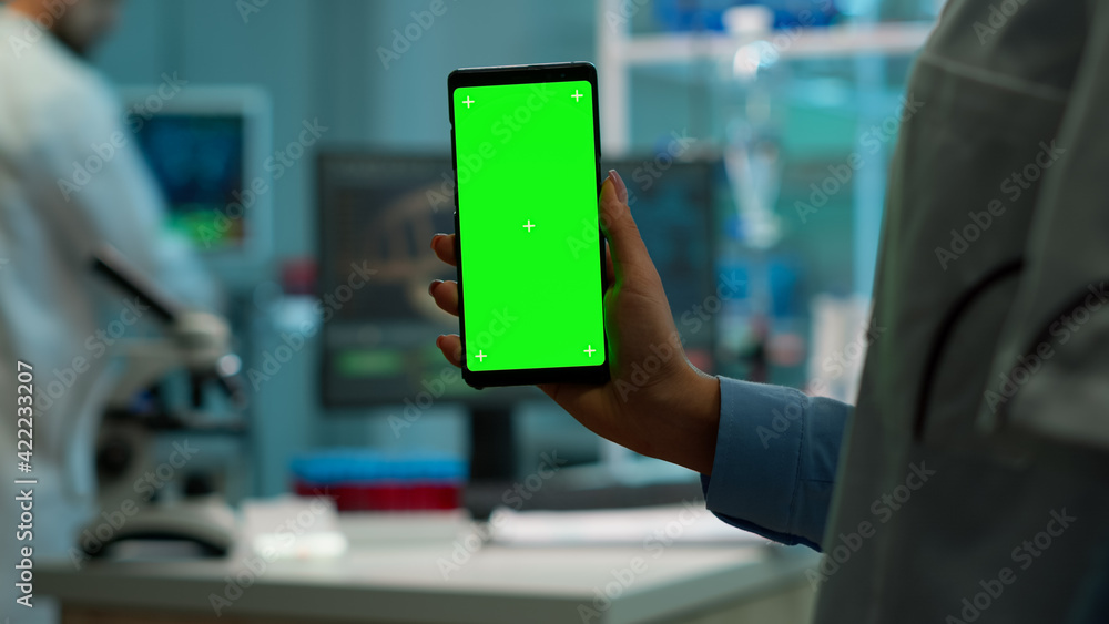 Poster chroma key isolated display on smartphone used by scientist woman in lab cabinet and colleagues in w