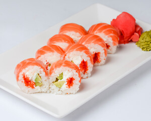 Sushi large set served on a white plate over white background. Traditional Asian Japanese cuisine concept.