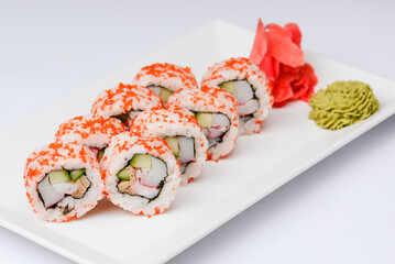 Sushi large set served on a white plate over white background. Traditional Asian Japanese cuisine concept.