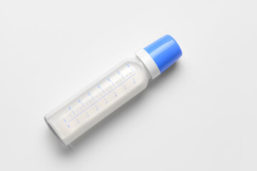 Bottle of milk for baby on white background