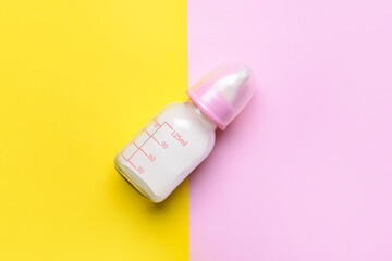 Bottle of milk for baby on color background