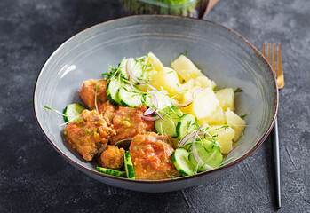 Steamed fish fillet with tomatoes sauce, boiled potatoes and fresh cucumber salad. Diet meal. Lenten food.