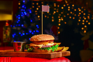 Classic deluxe cheeseburger with lettuce, onions, tomato and pickles on a sesame seed bun.
