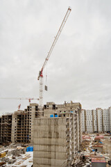 New construction of an unfinished multi-storey residential building. multi-storey residential building with cranes.