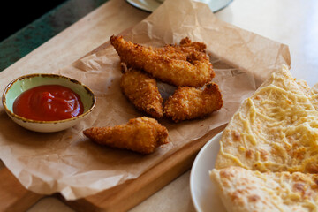 Lunch, chicken nuggets, tomato sauce and tortillas