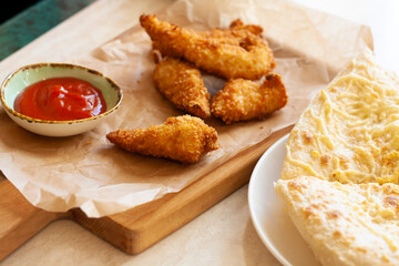 Lunch, chicken nuggets, tomato sauce and focaccia