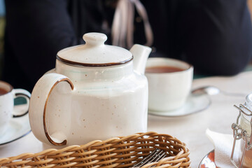 Tea is served on the table, teapot and cups