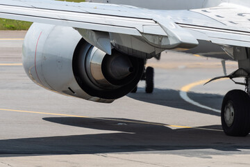 Turbofan jet engine under the wing of a modern narrow-body passenger aircraft.