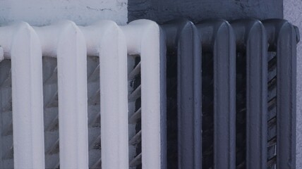 room old white battery painted half gray, painting the heating radiator in a dark shade, interior detail in the design of the room