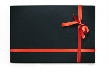 Black gift box with the red ribbon isolated on white