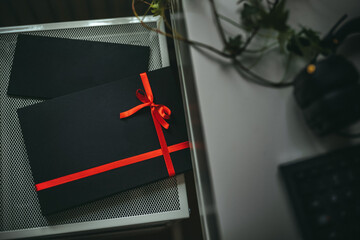 Black gift box with the red ribbon