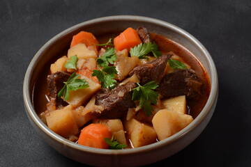 Irish stew made with beef, potatoes, carrots and herbs. Traditional St.Patrick's day dish, stewed in dark Guinness beer