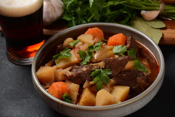 Irish stew made with beef, potatoes, carrots and herbs. Traditional St.Patrick's day dish, stewed in dark Guinness beer