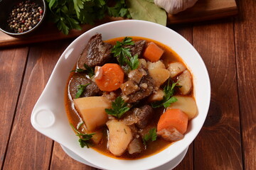 Irish stew made with beef, potatoes, carrots and herbs. Traditional St.Patrick's day dish, stewed in dark Guinness beer