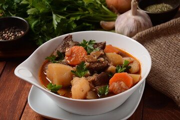 Irish stew made with beef, potatoes, carrots and herbs. Traditional St.Patrick's day dish, stewed in dark Guinness beer