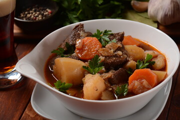 Irish stew made with beef, potatoes, carrots and herbs. Traditional St.Patrick's day dish, stewed in dark Guinness beer