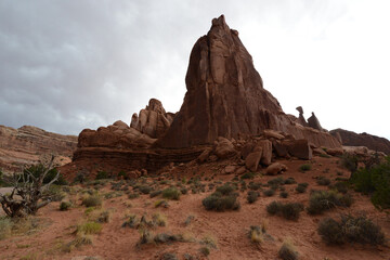 Fototapeta na wymiar Moody view of the red sandstone formations at Arches National Park in Utah on a cloudy and stormy day